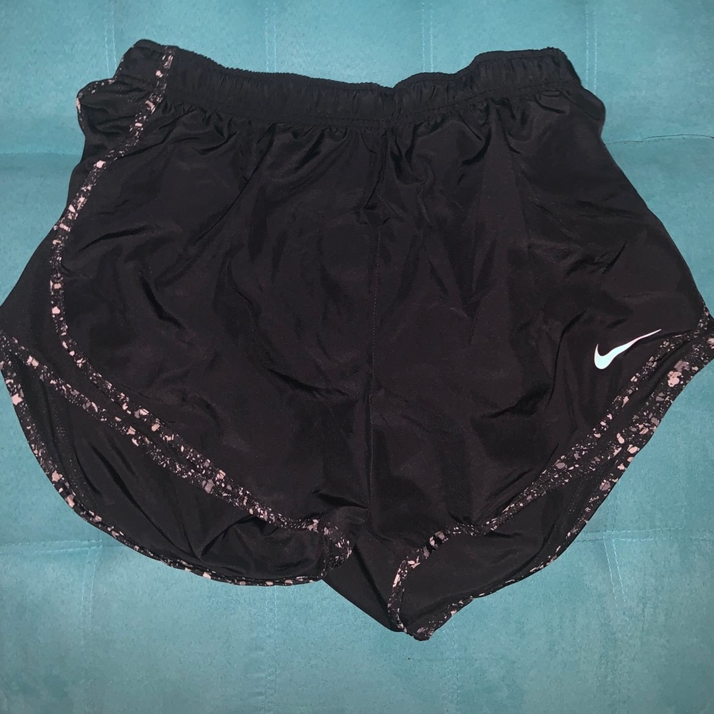 black nike shorts with white patterned trim